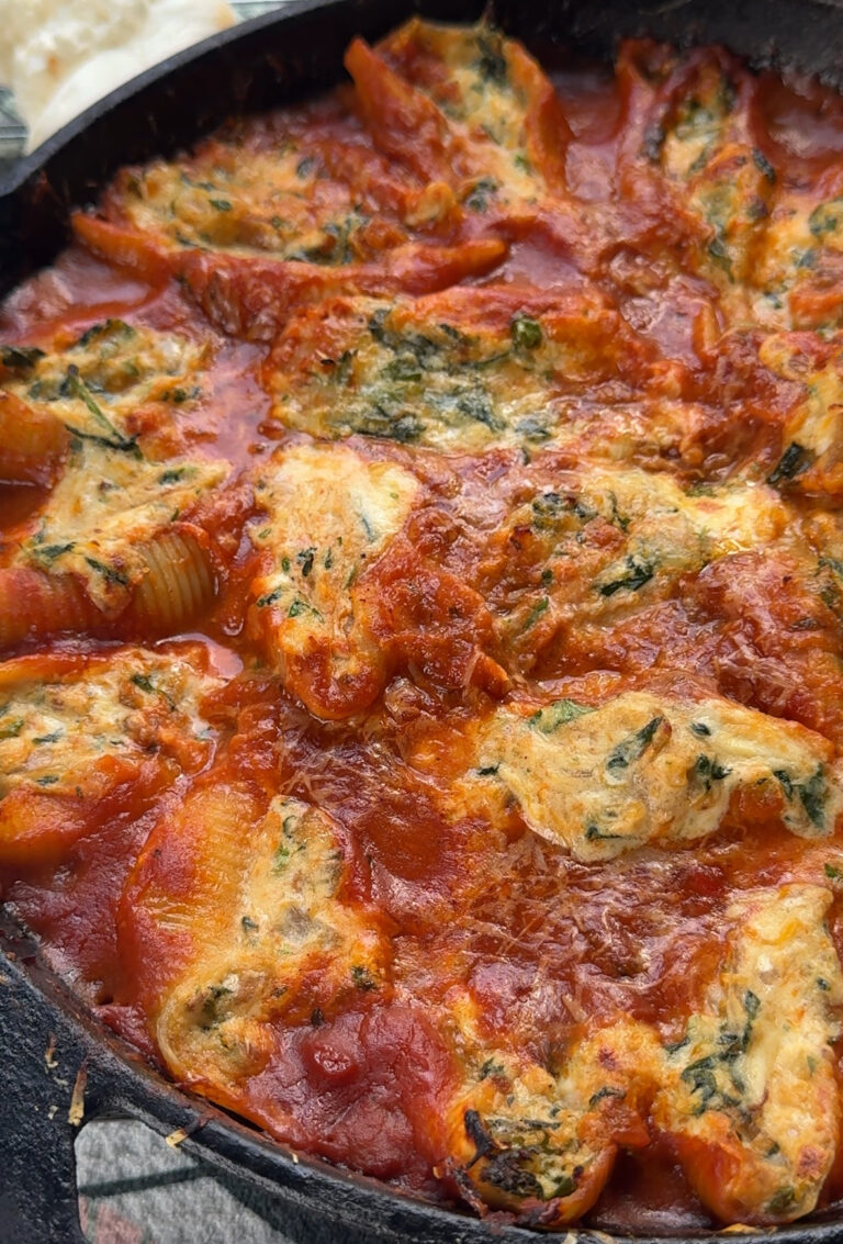 cooked pasta shells in a cast iron stuffed with butternut squash, ricotta and spinach and topped with more red sauce sauce