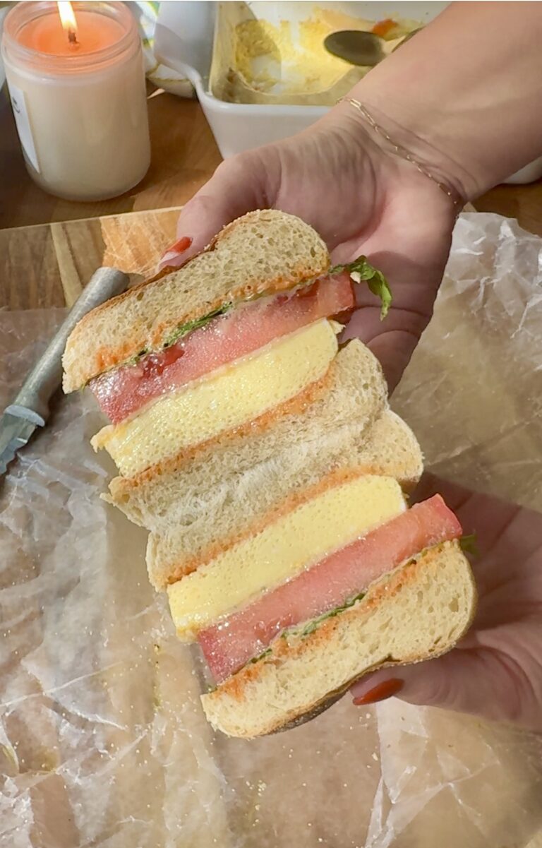 Fluffy egg sandwich cut in half showing the inside of the sandwich