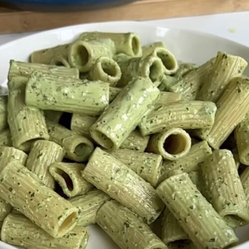 Tahini basil pasta sauce in a white bowl.