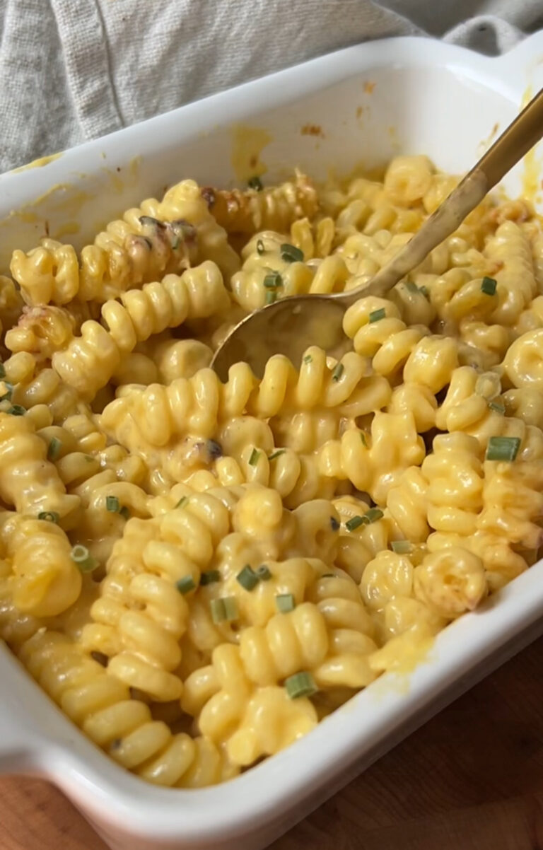 dish with curly pasta herbs and cheese sauce