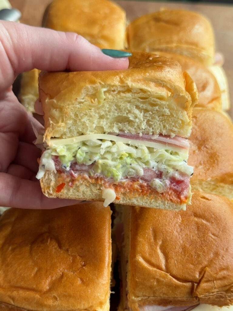 1 italian grinder slider being held above the others