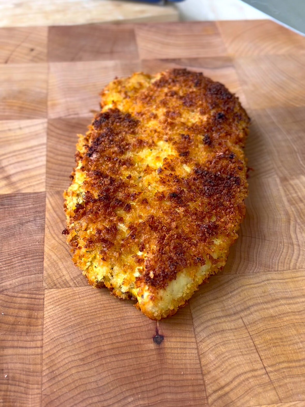 crispy chicken cutlet on a cutting board