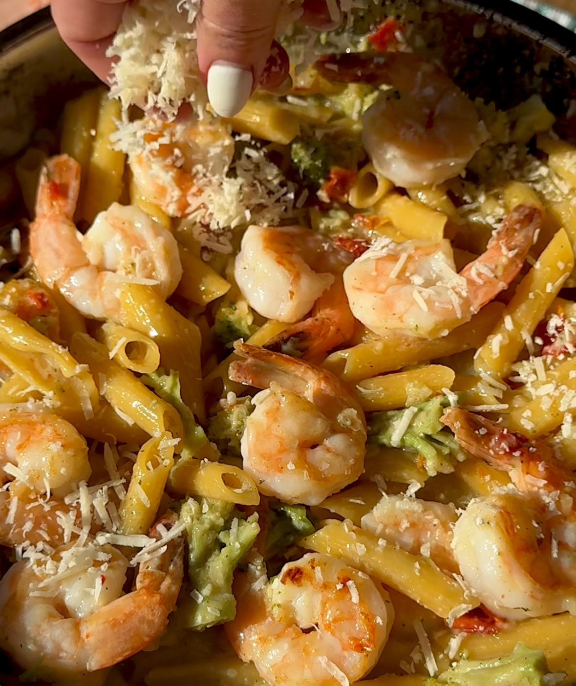 penne pasta mixed with broccoli shrimp and Parmesan cheese