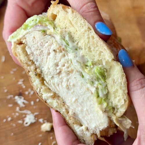half a thick hummus crusted chicken sandwich with an iceberg slaw
