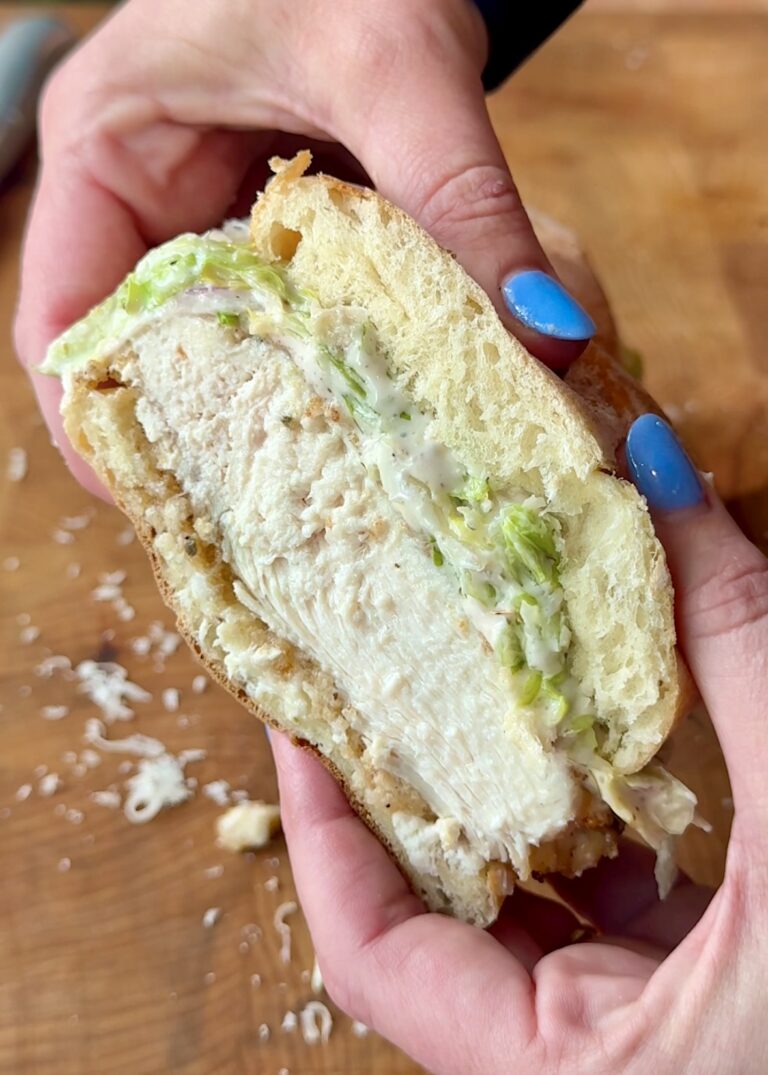 half a thick hummus crusted chicken sandwich with an iceberg slaw