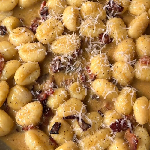 gnocchi in a creamy carbonara top with Parmesan cheese