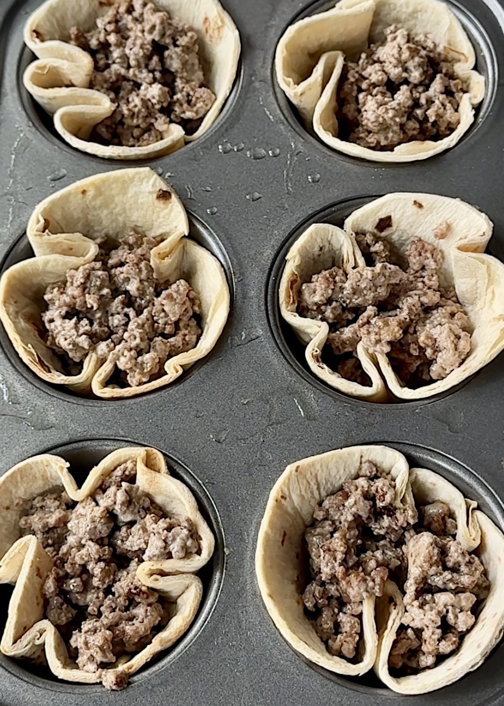 Big Mac Taco Cups baked to golden perfection in a muffin tin.