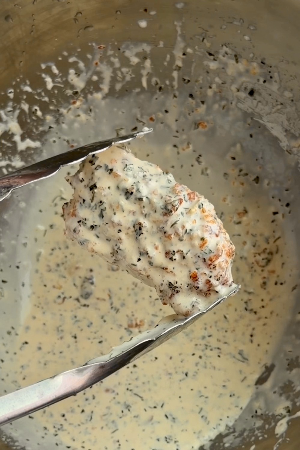 Garlic parmesan boneless wings coated in creamy sauce and topped with parmesan